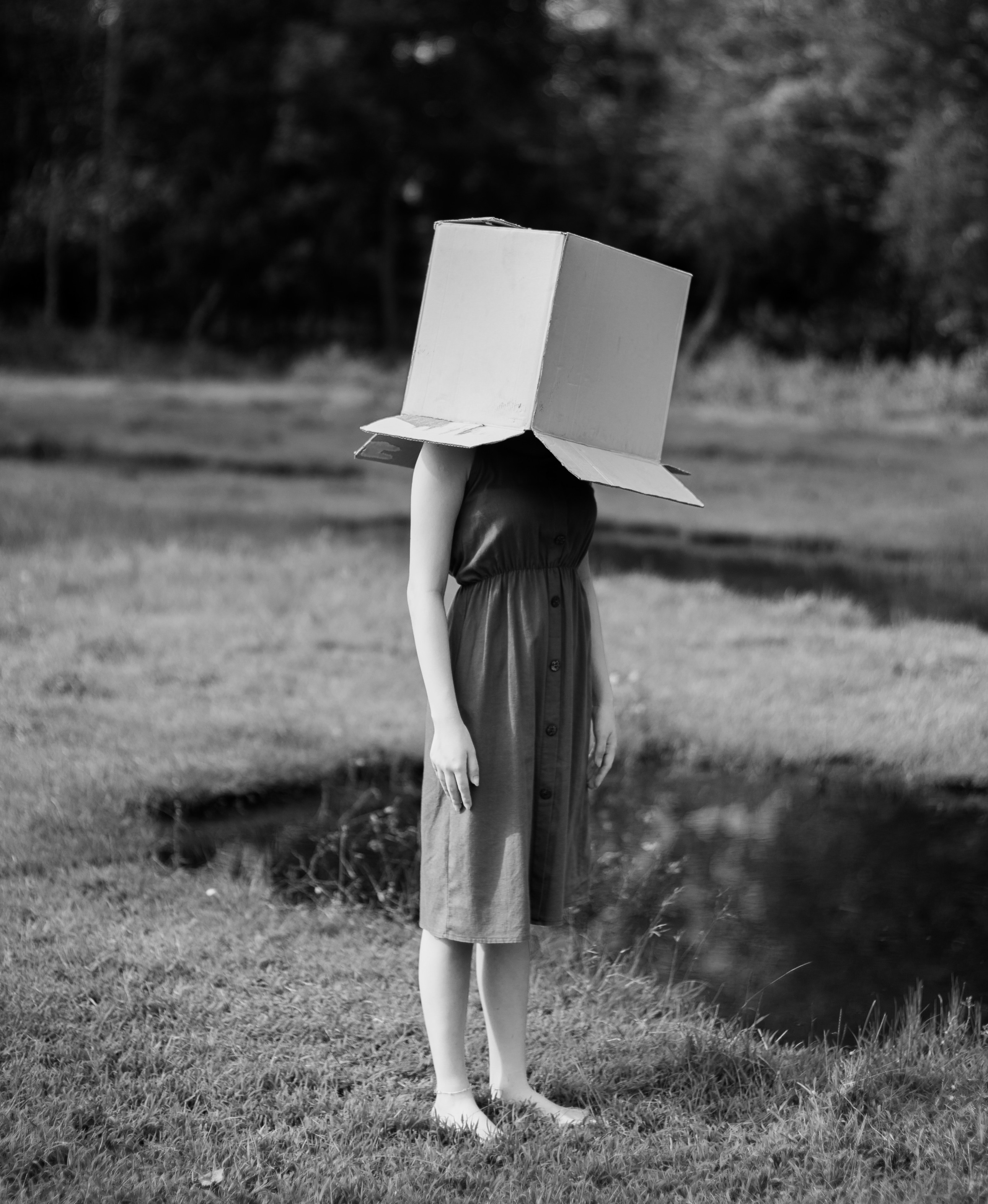 Girl with box over her head.