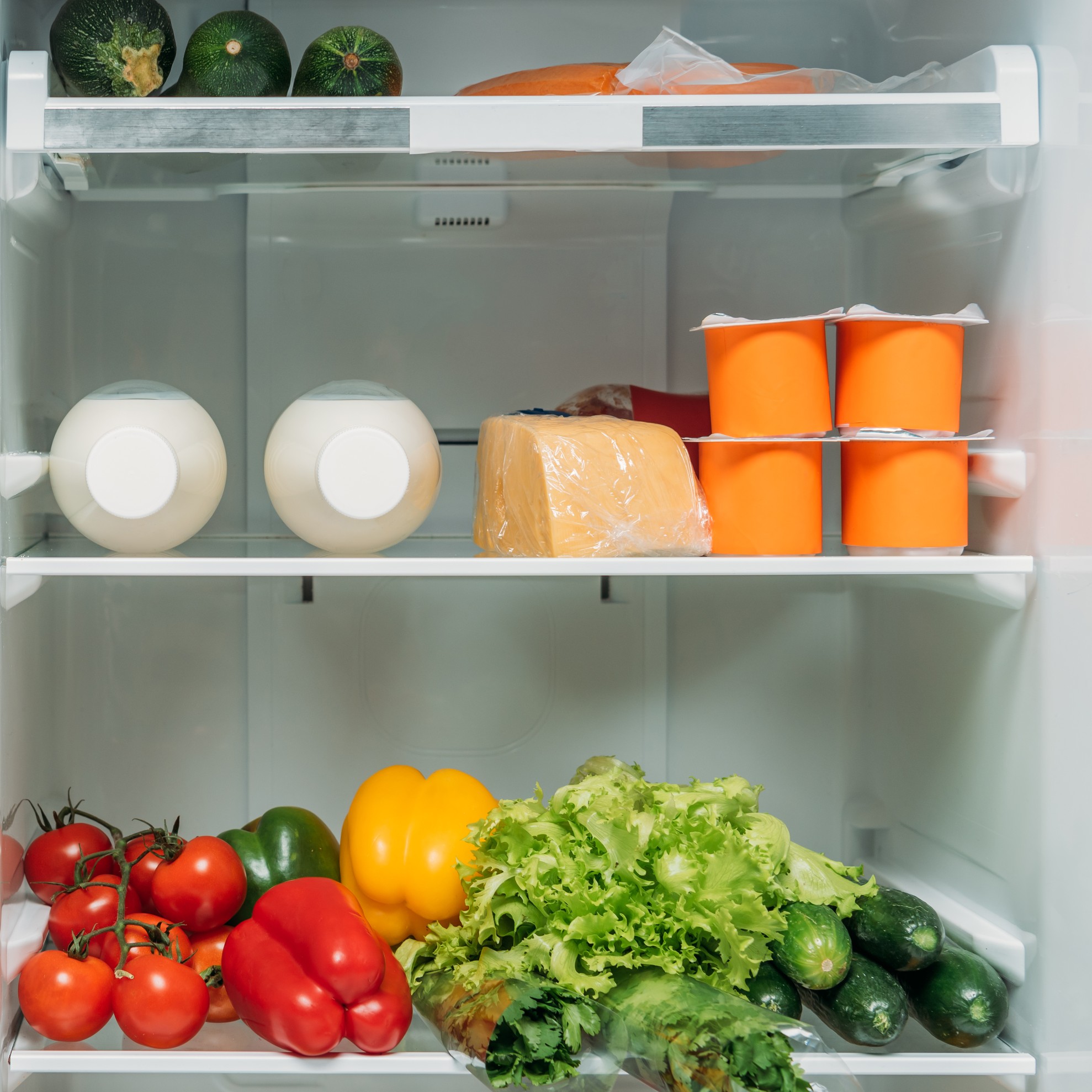 Refrigerator full of food and groceries.